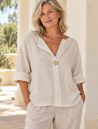Zamma Relaxed V-Neck Top in beige, styled on a mature woman in a light summer setting