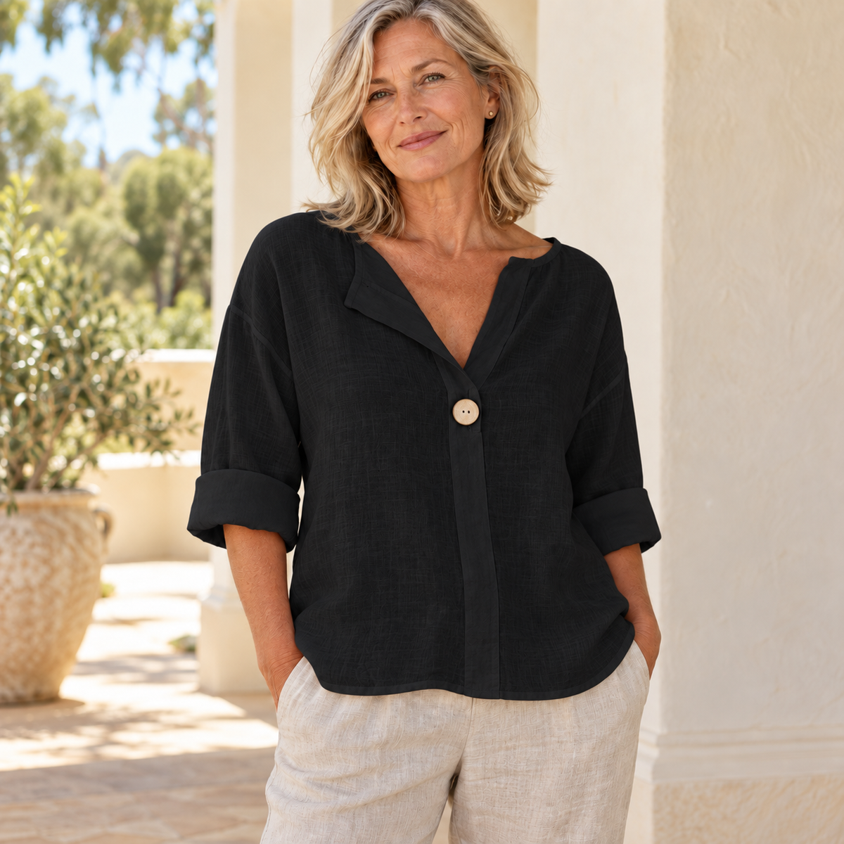 Zamma Relaxed V-Neck Top in black, styled on a mature woman in a light summer setting