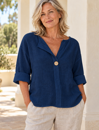 Zamma Relaxed V-Neck Top in navy blue, styled on a mature woman in a light summer setting