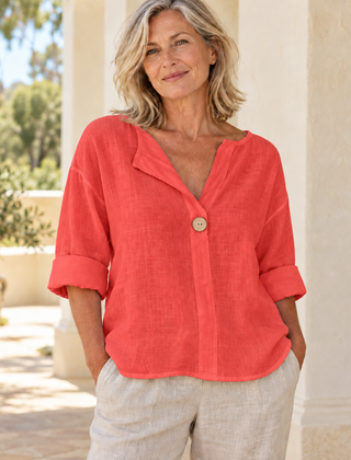 Zamma Relaxed V-Neck Top in red, styled on a mature woman in a light summer setting