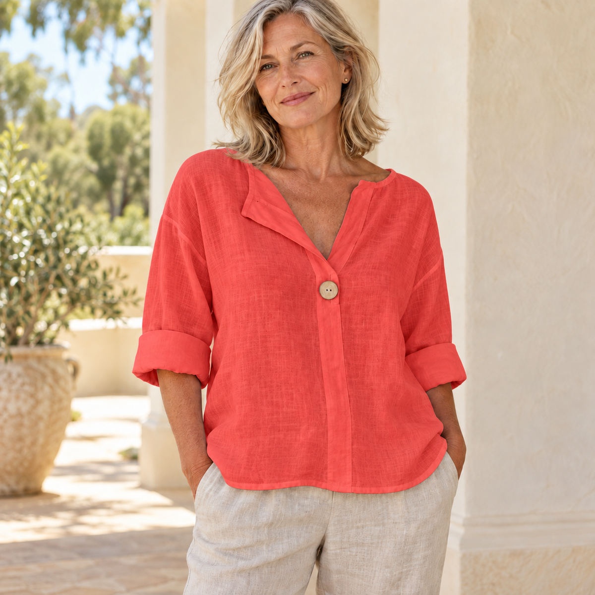 Zamma Relaxed V-Neck Top in red, styled on a mature woman in a light summer setting